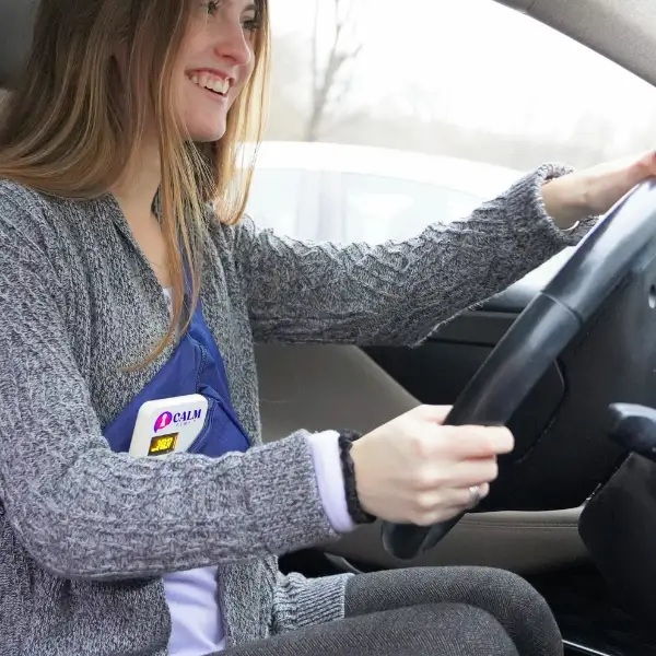 Woman smiling while driving a car