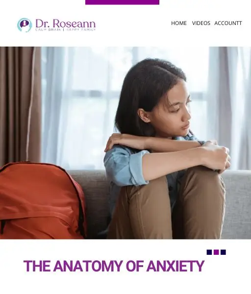 Teen girl sitting on couch with arms wrapped around herself