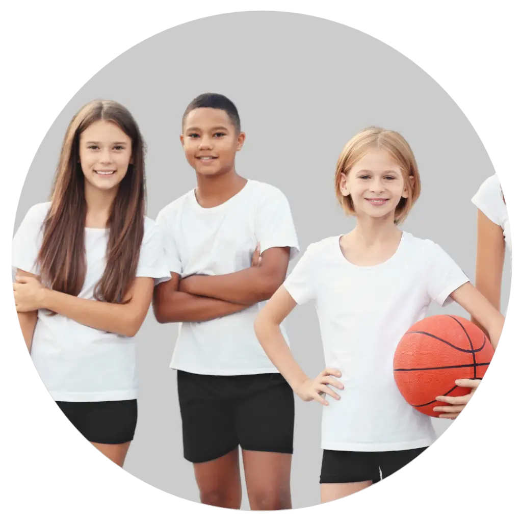 Three children in white shirts smiling, one holding a basketball