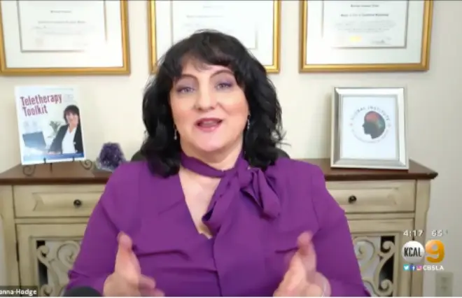 Dr. Roseann Capanna-Hodge in purple top during television interview