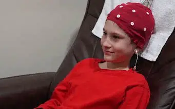 Child wearing an EEG sensor cap