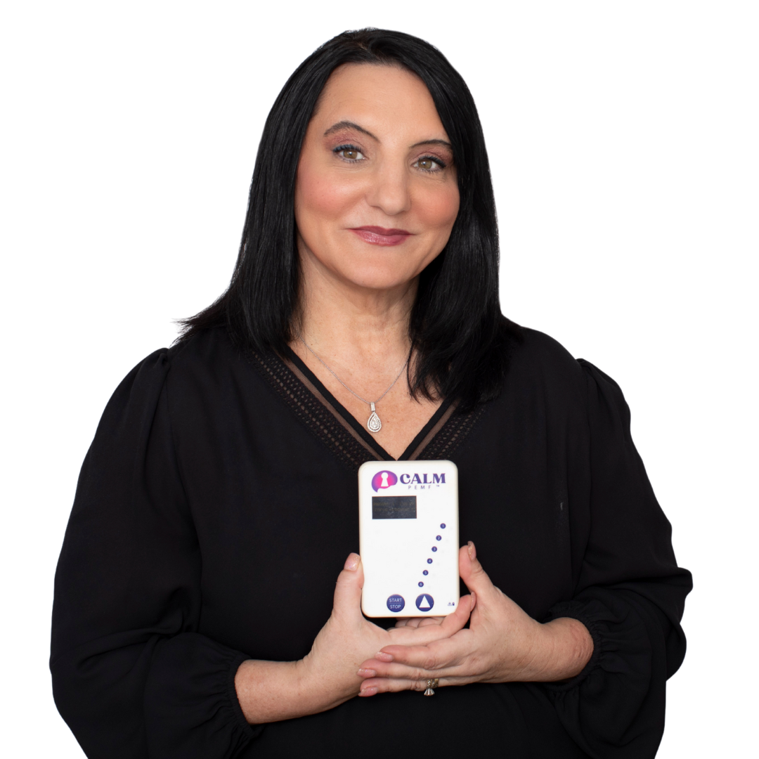 Dr. Roseann Capanna-Hodge holding white CALM PEMF device