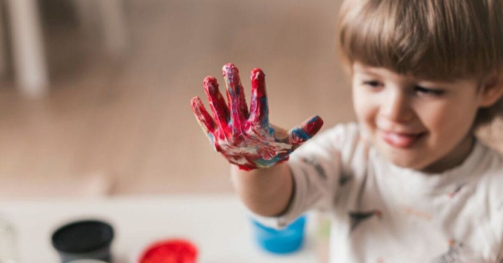 child learning cognitive skills with painting and art