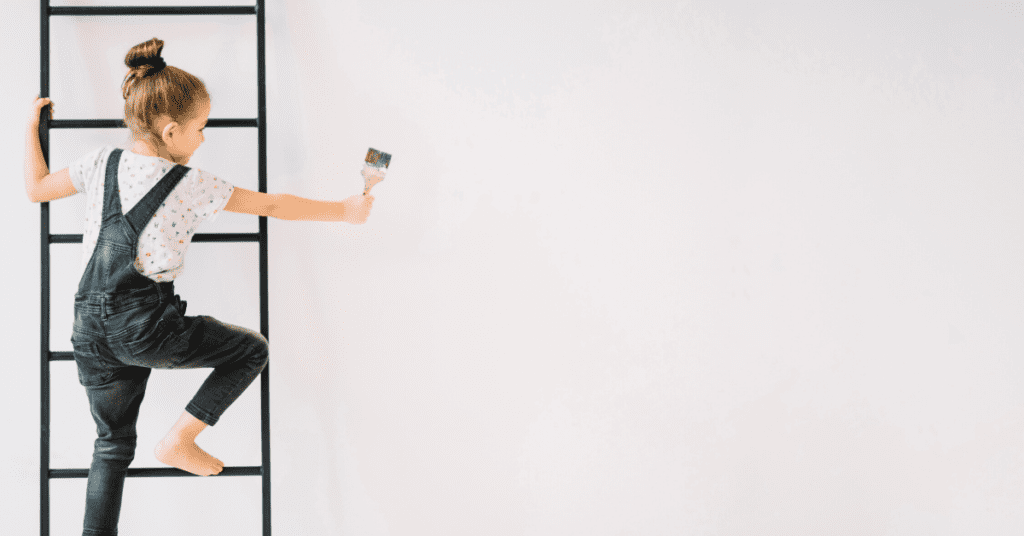 Girl on a ladder with a paintbrush