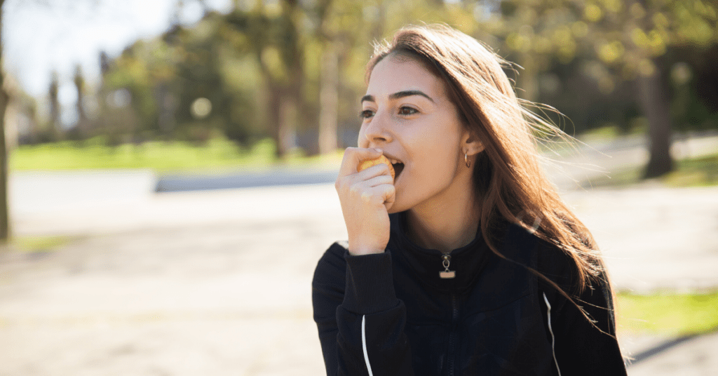 Women eating an apple outside