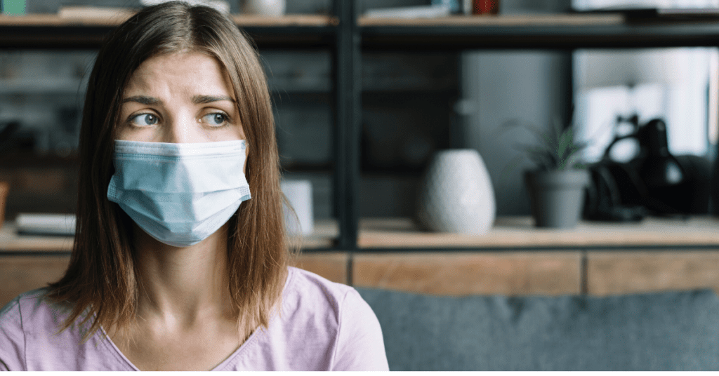 A woman exhibiting Fear Of Going Out (FOGO) by wearing a surgical mask.