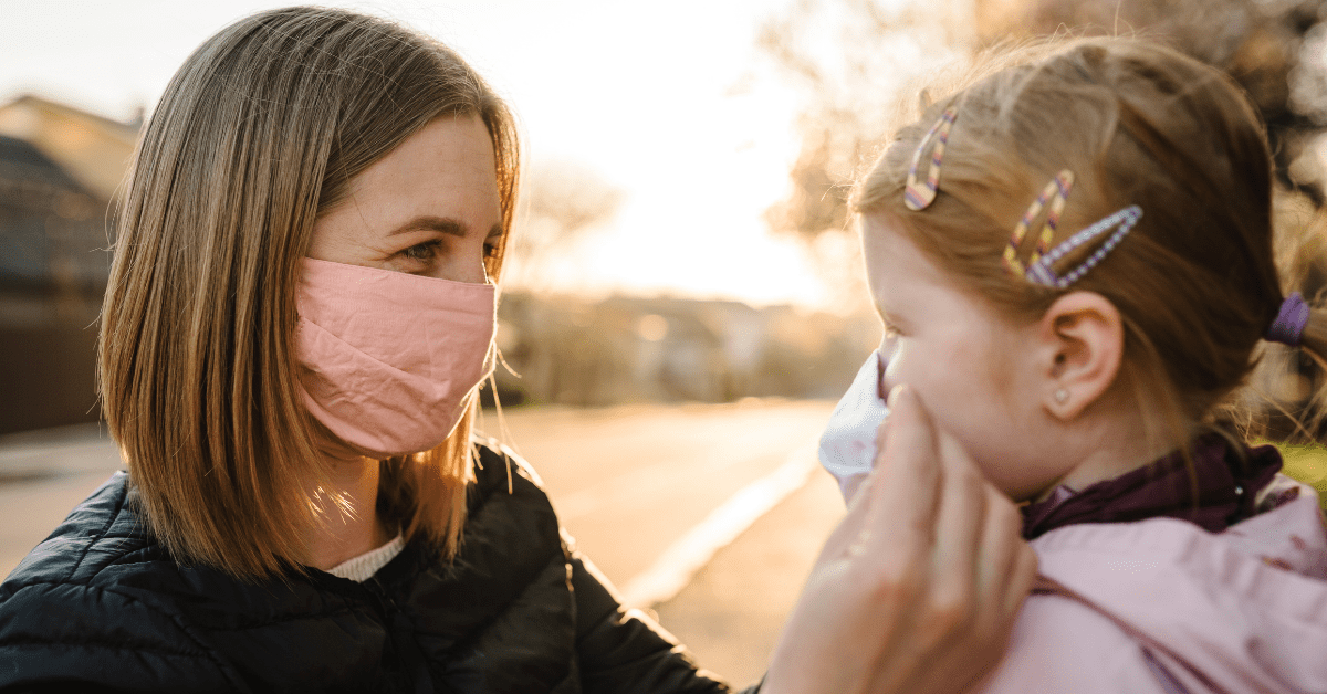 A woman and a girl wearing face masks show how to function in times of uncertainty.