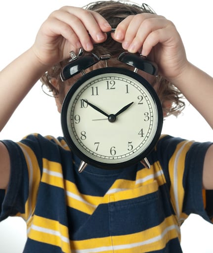 child holding clock | Dr. Roseann