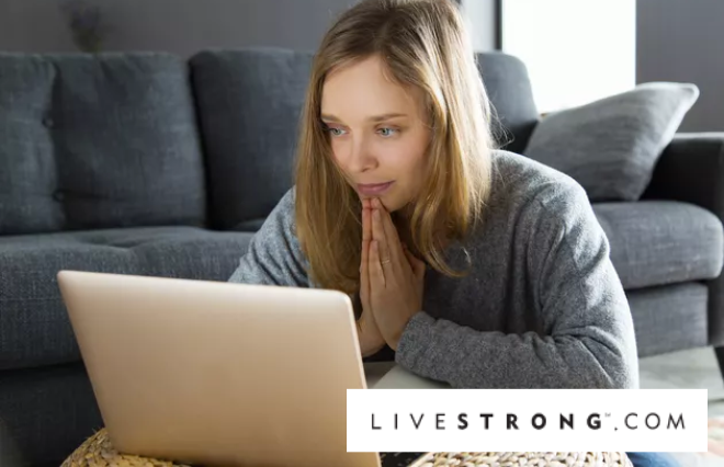 A woman browsing livestrong.com on her laptop.
