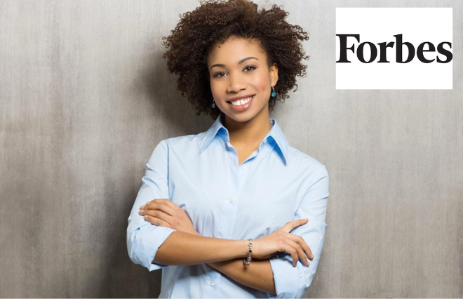 A young woman showcasing confidence and authority in front of the Forbes logo, representing the media kit.
