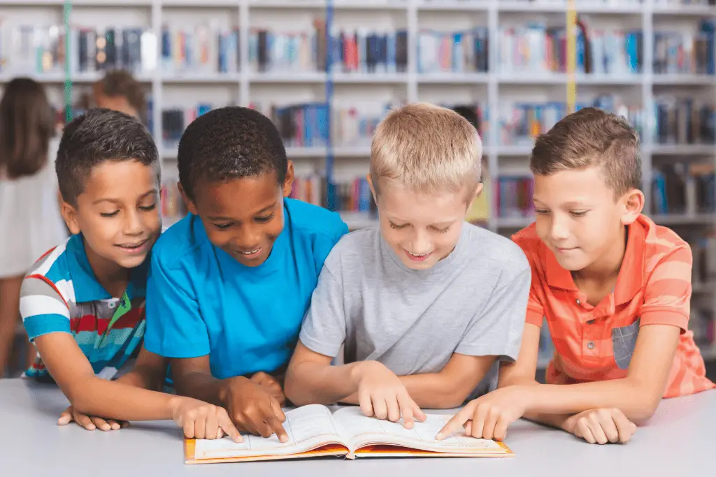 A group of children, including those with autism and ADHD, reading a book in a library.