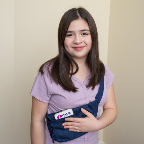 A calm young girl wearing a blue fanny pack.
