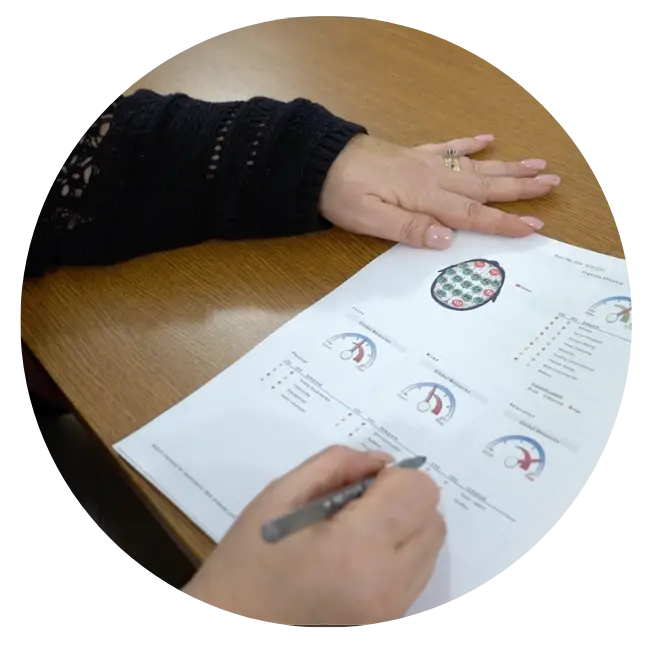 A person using neurofeedback while writing on a piece of paper.