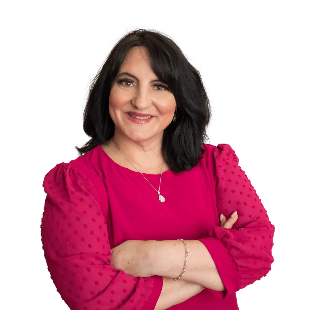 A woman receiving stress treatments, with her arms crossed and wearing a red top.